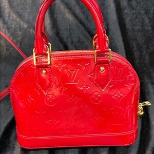 Louis Vuitton Alma BB handbag in a red Monogram Vernis leather finish